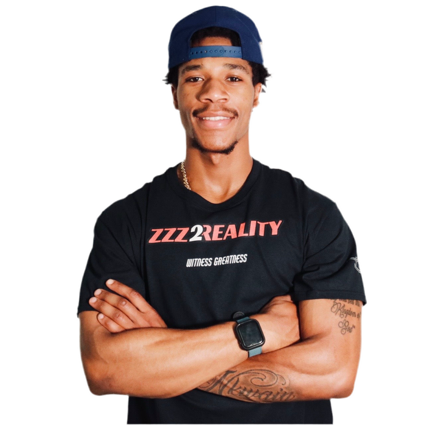 Model wearing the black Dreams To Reality Tee, front, with the red and white ZZZ2REALITY chest print