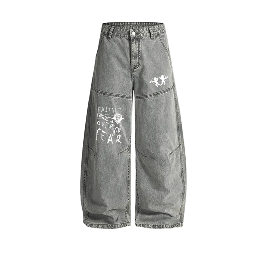 Washed grey Curved Blade denim jeans, baggy wide leg with a curved seam down each leg, white twin cherub archers on one thigh and a hand-lettered Faith Over Fear graphic on the other