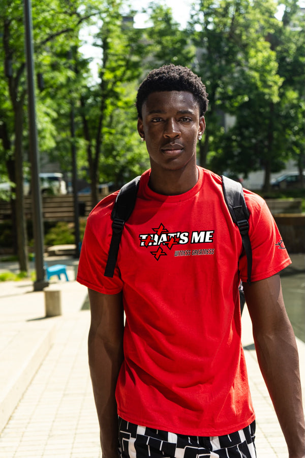 Model wearing the red That's Not Me Tee outdoors, front, with the struck-through THAT'S ME star print
