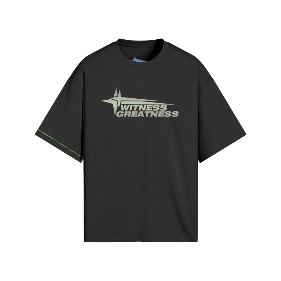 Black oversized WG Uplifted Tee, front view with the sage green Witness Greatness star wordmark across the chest and contrast green side seam stitching
